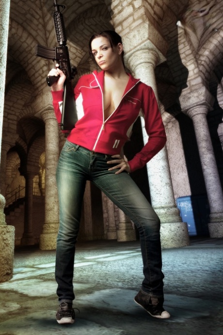 Brunette cosplayer releases her big tits while holding a rifle