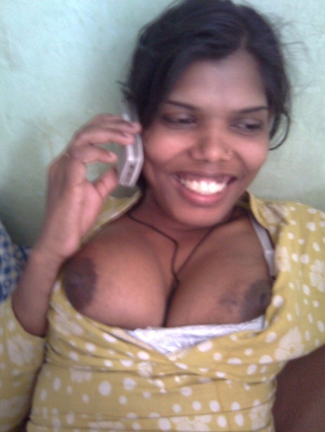Indian woman exposes her large boobs and upskirt panties in bedroom