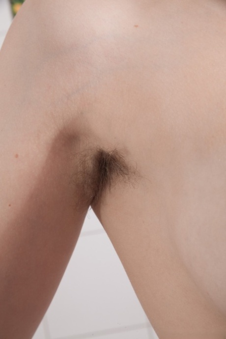 Hairy blonde girl Lavatta W masturbates in the bathroom in solo action