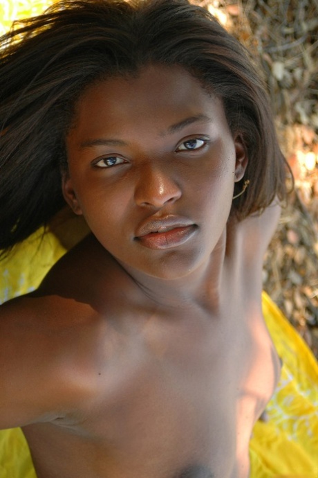 Glamorous ebony teen Geisha A showing her sexy naked curves in nature