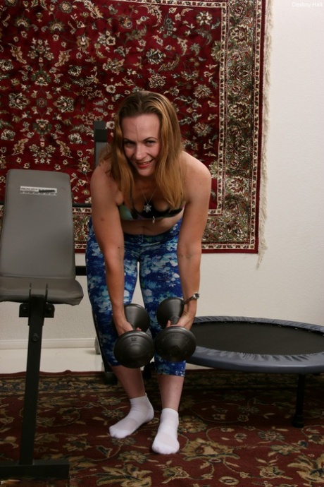 Mature Destiny Hall unveils her saggy tits & her MILF pussy during a workout