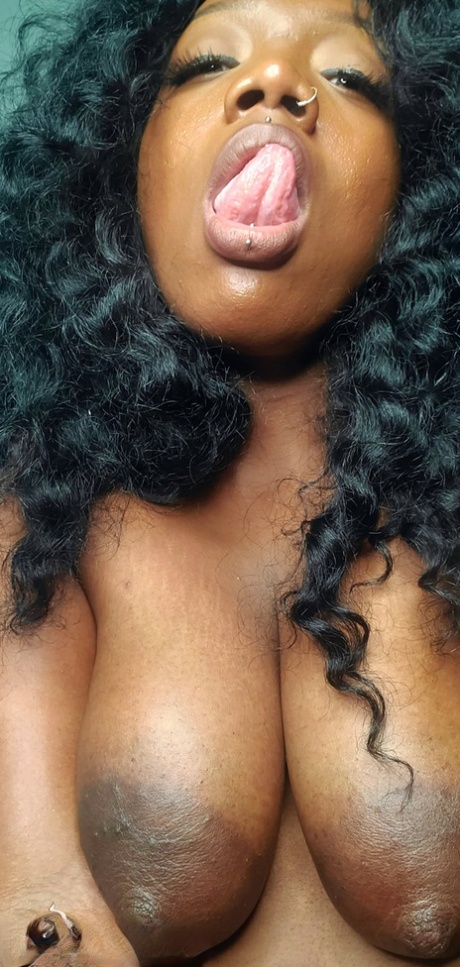 Ebony fatty with big saggy tits Chy Latte sucking and licking a glass toy